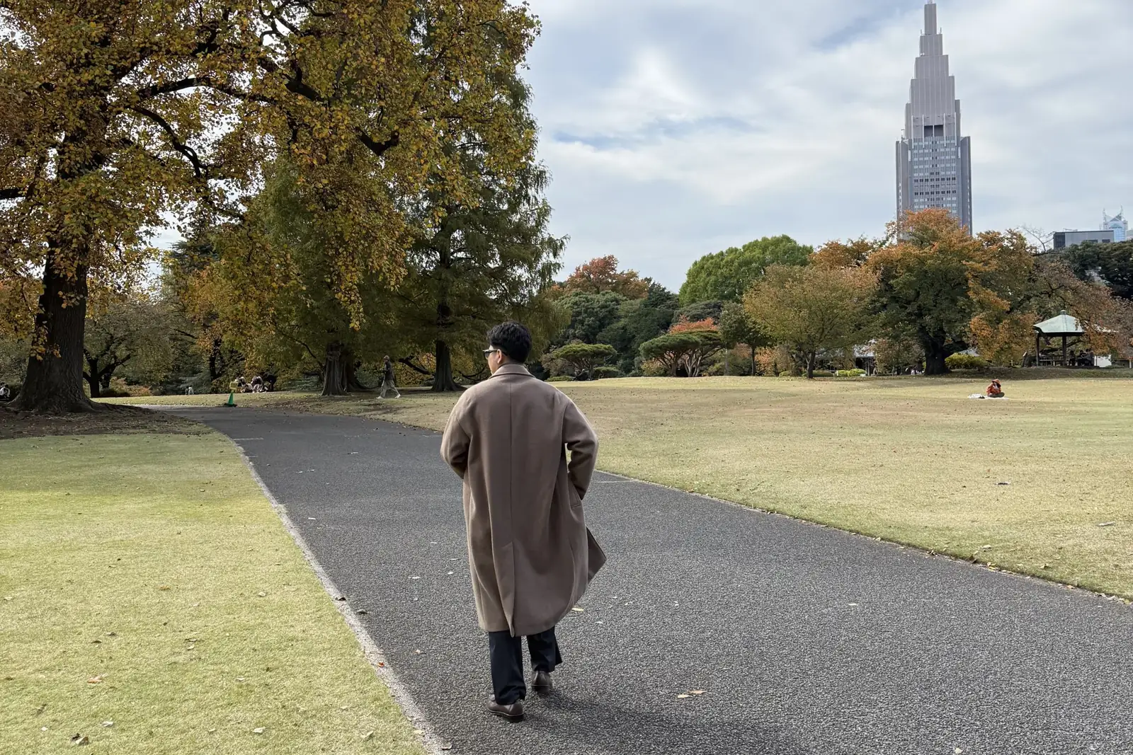 Zefanya Adriel walking through a Tokyo park in autumn